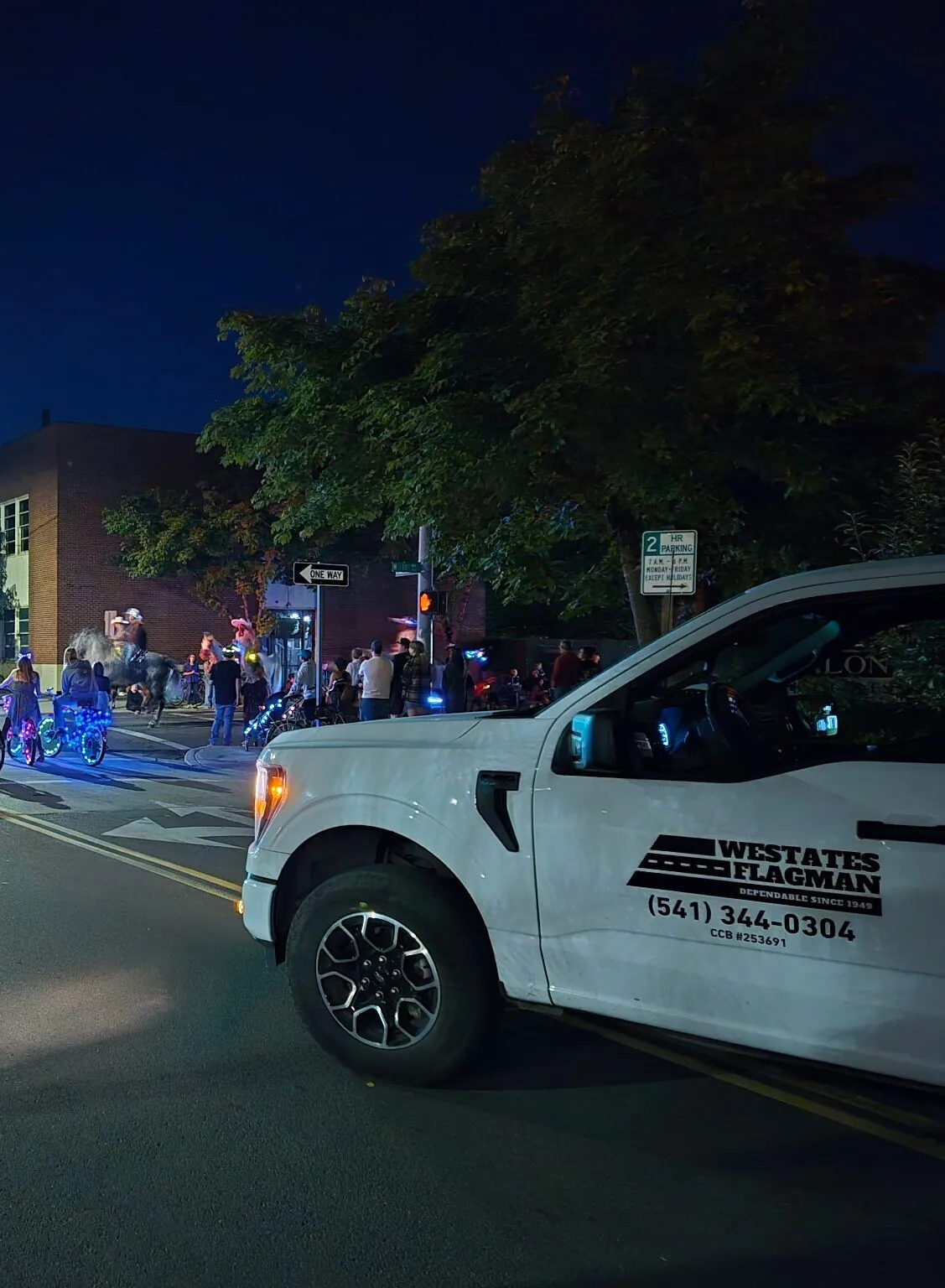 Westates Flagman branded truck at Eugene Bright Parade providing night event traffic control